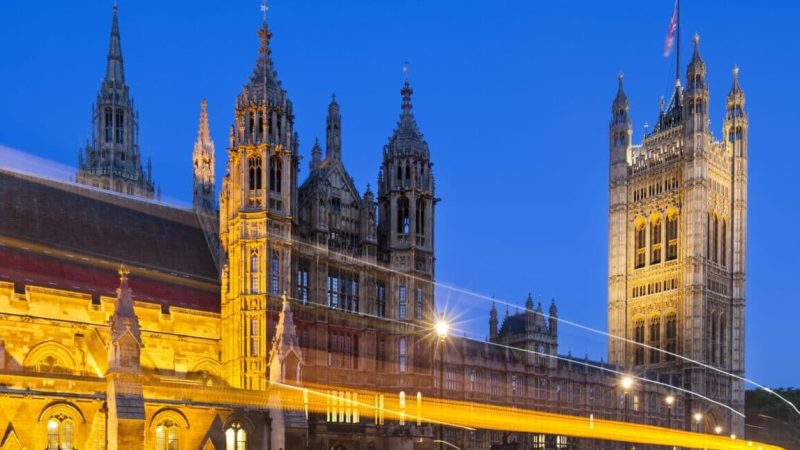 Houses Of Parliament At Night Long exposure night shot of the Houses of Parliament in London with blue sky and a street in the foreground.